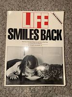 Front cover showing title, LIFE logo, photo of girl and kitten