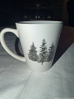 Full view of mug with handle and tree design