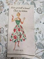 Full view of dish towel showing artwork, text and border