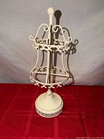 Full view of cream two-tier metal jewelry holder
