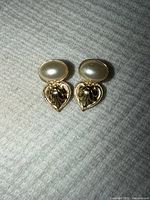 Front view showing overall design with faux pearl tops and ornate teardrop drops