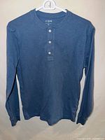 Front view of blue J.Crew long-sleeve Henley on hanger