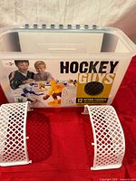 Front view of labeled storage bin and two goals