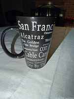 full view showing handle and printed city landmark names