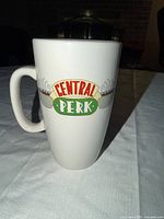 Front view of white mug displaying Central Perk logo