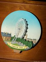 Front view of round relief plate showing London Eye scene