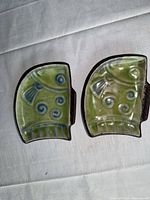 front view of two ceramic fish trays showing glaze and design