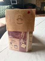Front view of sealed mini folk doll kit showing fabric pack and header