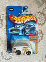 Front view of sealed Hot Wheels 2004 First Editions #012 car on card