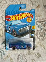 Front of sealed Hot Wheels Draftnator card showing car and series info