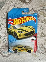 Front of sealed Hot Wheels card showing Aston Martin One-77 HW Rescue 4/10