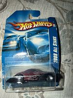Front view of sealed Hot Wheels Swoop Coupe car on 2008 All Stars card