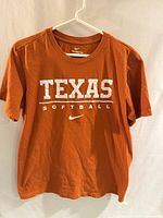 Front view of Nike Texas Softball t-shirt on hanger