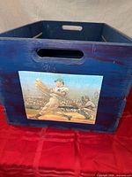 Front of blue crate showing Yankees batter graphic and hand hole