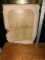 Full view of mounted photograph showing two men and overall board condition