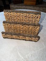 Front view of woven wicker three-slot desk organizer