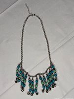 Full view of necklace laid flat showing fringe design