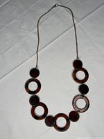 Full view of necklace displaying resin rings and chain