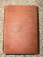 Front cover of brown cloth hardcover showing title and wear