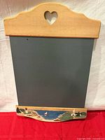 Full view of chalkboard showing wood frame, heart cutout, slate surface
