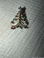 front view showing tree design with multicoloured rhinestones and star topper