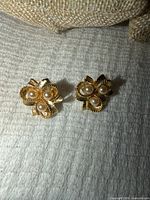 Front view showing pearl arrangement and gold tone floral design