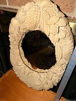 Front view of mirror showing full ornate fruit relief frame