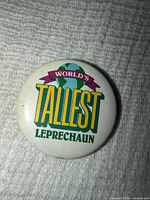 Front view of circular pin showing full text and design