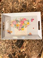 Top view showing full tray, handles, floral and insect design