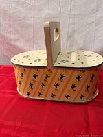 overall view showing oval shape and side floral stripe paint