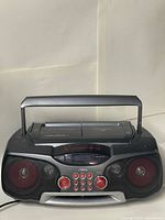 Front view showing speakers, controls and handle