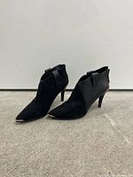 full view of both ankle booties, side profile, showing suede and leather mix