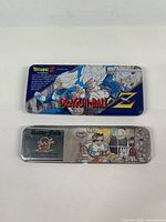 Top view of Dragon Ball Z and Daddy Field tin pencil case lids