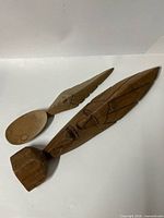 Both carved wooden pieces side by side showing overall design and relative size