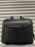 Front view showing Dell logo, leather finish and flap