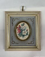 Front view of framed floral print showing full frame and hanging hook