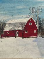 Close view of painted red barn and snowy foreground