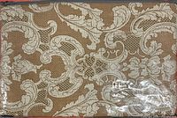 Front of packaged bedding set showing damask pattern