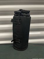 Front view of black insulated bottle holder standing upright