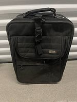 Front view of suitcase showing exterior pockets and handle