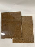 Two rectangular glass photo holders stacked, showing glass front and MDF back