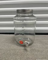 Front view of glass dispenser showing capacity markings and spigot