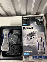 Shaver, stand, accessories and retail box overview