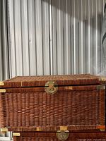 Front view of closed rattan trunk highlighting weave and latch