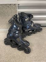 Side view of both inline skates showing boot, frame and wheels