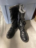 Front view of both black winter boots standing together