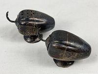 Oblique view of both acorn shakers showing form and tarnish