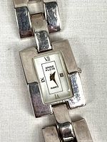 Close-up of watch face showing brand, dial, and bracelet detail