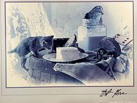 Close view of artwork imagery showing kitten, barrel, butter, milk jar, bird