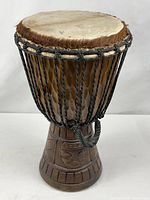 Full view of djembe showing drumhead, rope system and carved base